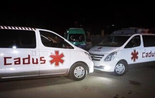 Ambulances financed by CADUS standing in a parking lot of Heyva Sor, ready for deployment.